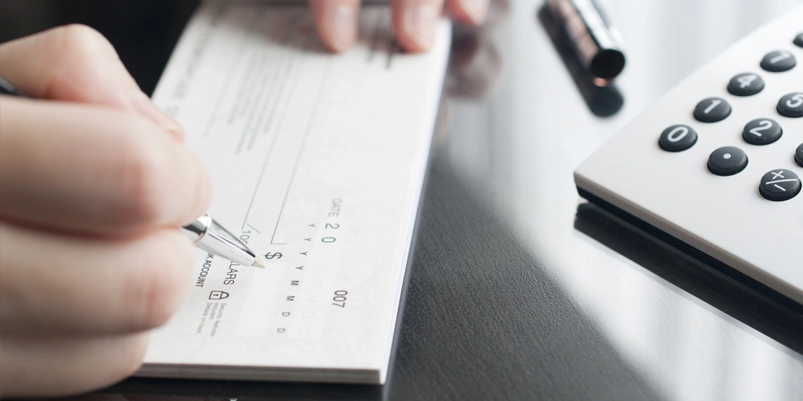 A man writing a cheque