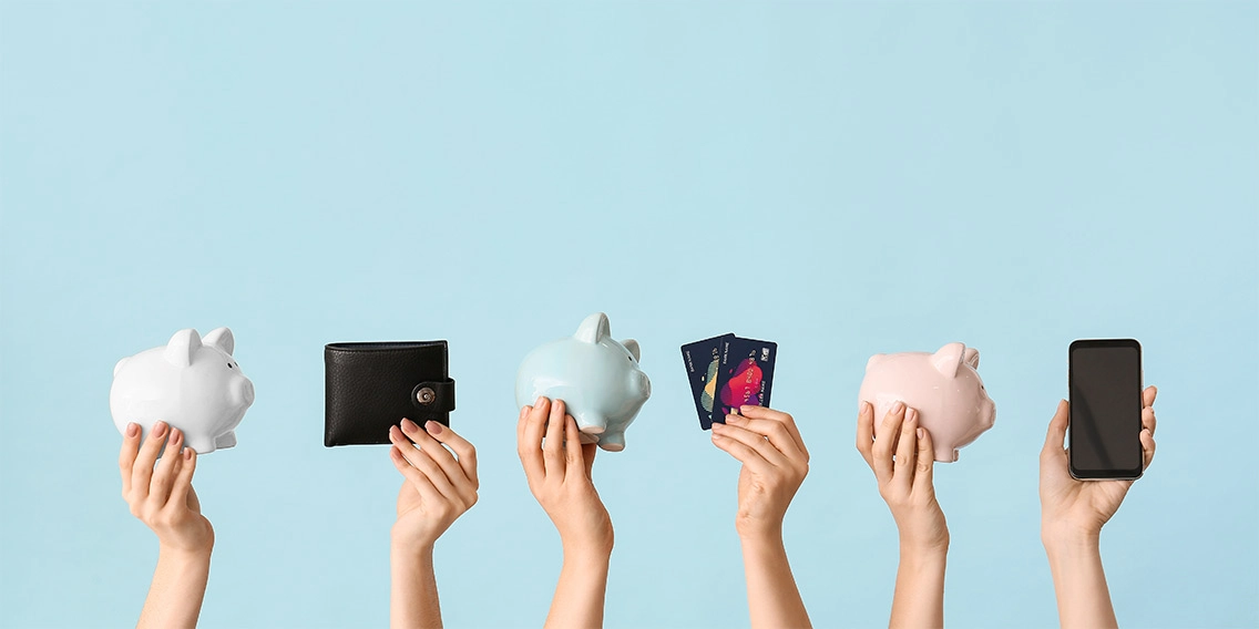 hands holding credit cards, wallets, and piggy banks