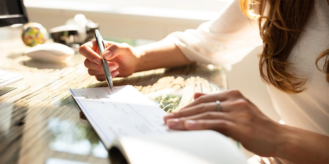 A lady writing cheque