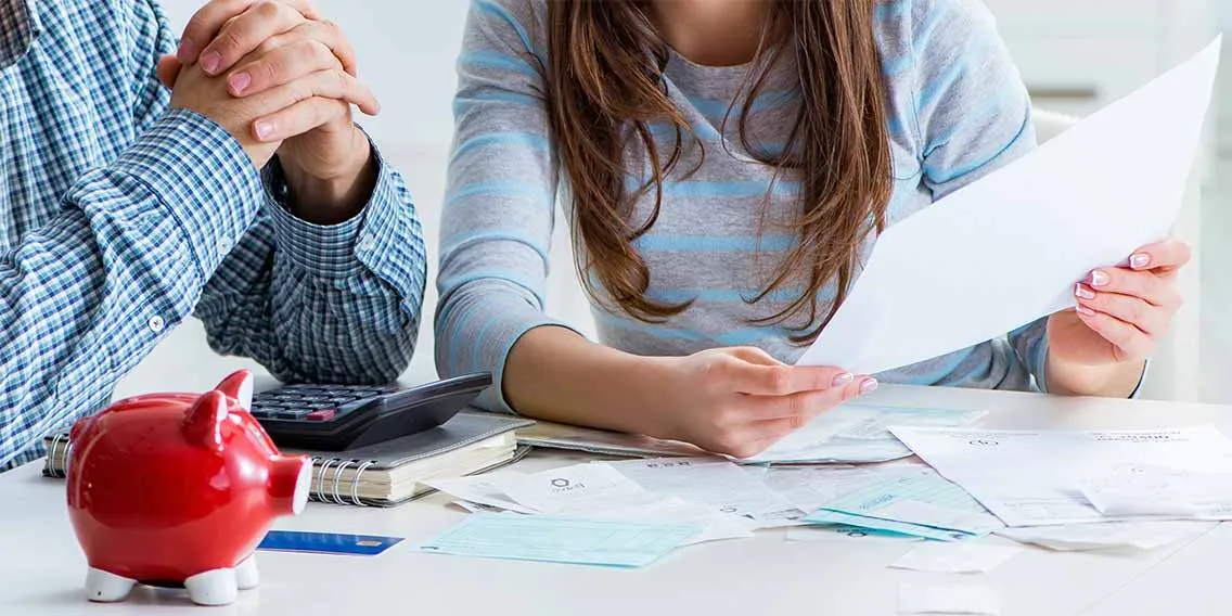 two people sitting on a table and discussing about Personal Loan