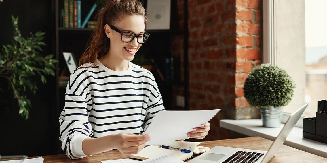 woman at laptop looking at documents