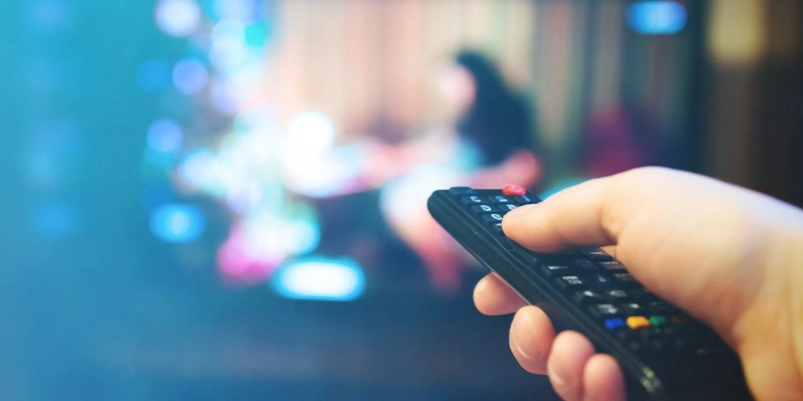 A man holding a remote