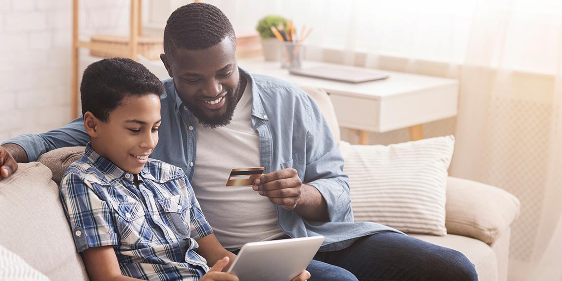 A man and a boy looking at the card