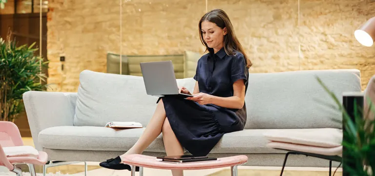 Women sitting in waiting area with laptop