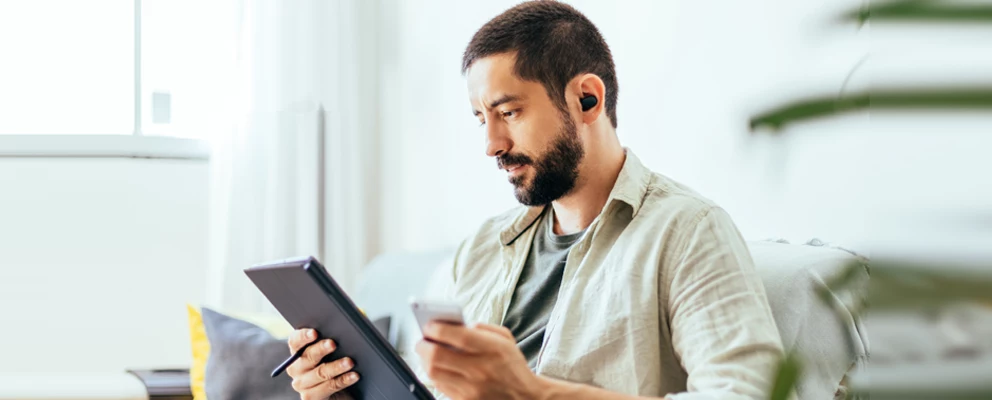 man interacting with tablet