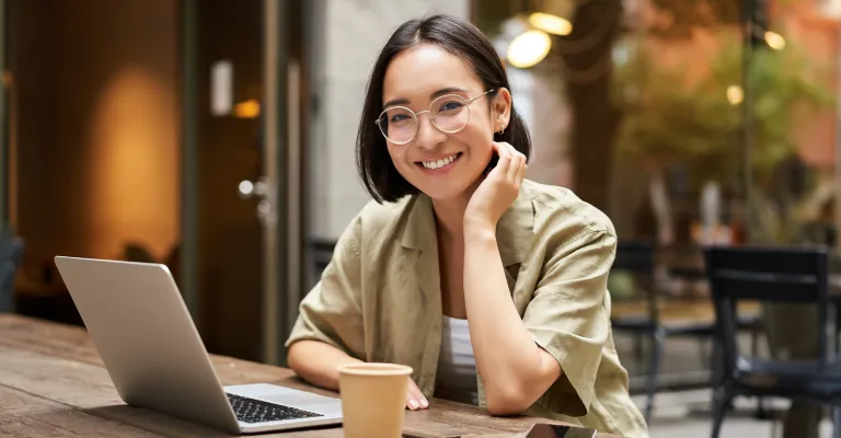 Woman sitting at her desk with her laptop