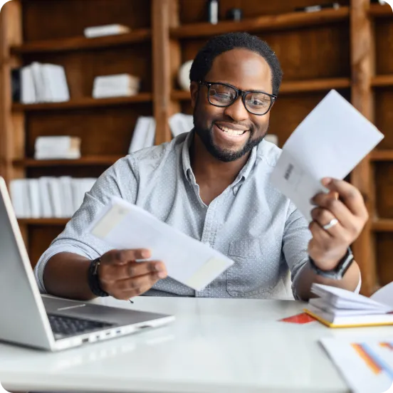 Man reviewing mail and letters on his desk