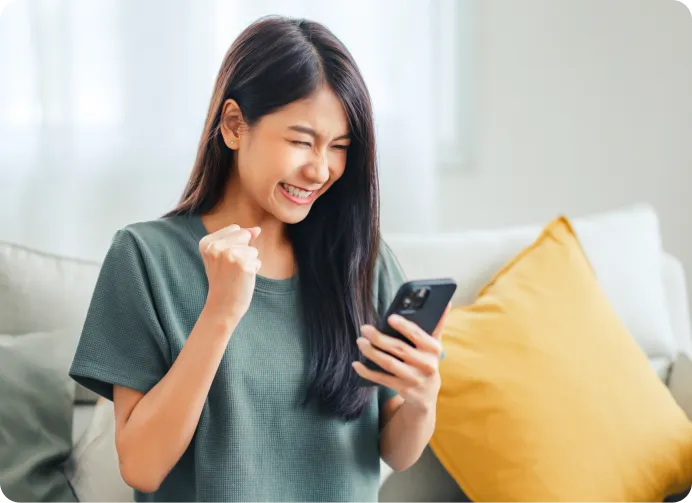 a girl smiling while looking at the phone