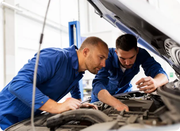 two mechanic men repairing a car