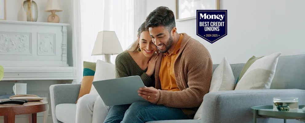 a couple sitting on a couch with a smiling face