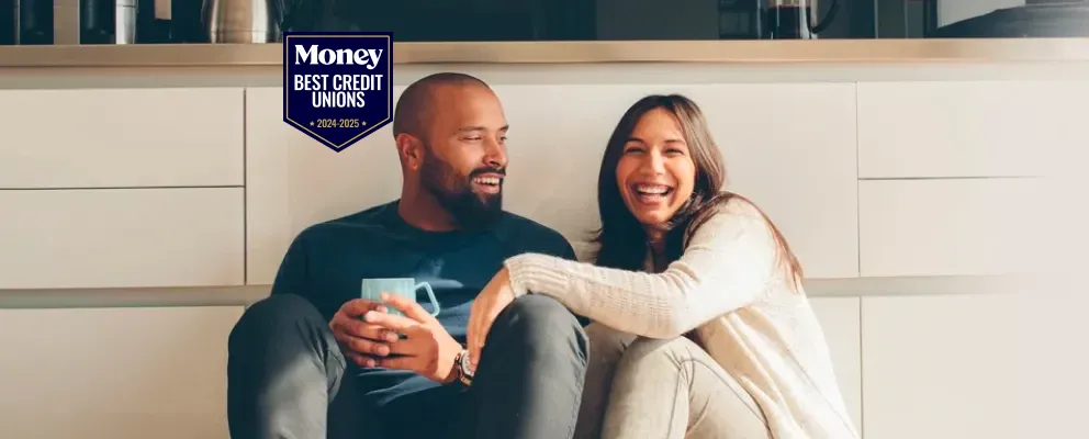 smiling couple sitting on the floor