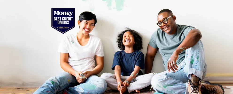 Smiling family sitting together on floor